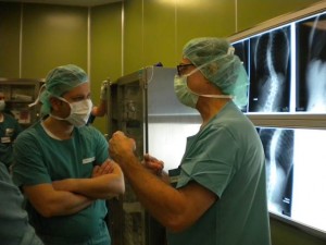 Dr Vasko Jablonski (left) discussing a scoliosis surgery (xrays in background) with Dr Steven Mardjetko of the Scoliosis Research Society.